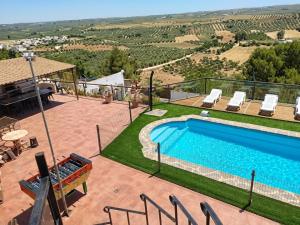 a swimming pool with a view of the countryside from a house at Casas Cueva con piscina y barbacoa in Fontanar
