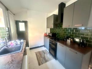 a kitchen with a sink and a stove at 1 Bed & Breakfast West Brom in West Bromwich