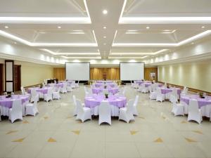 a large banquet hall with purple tables and white chairs at Mercure Resort Sanur in Sanur +114 photos