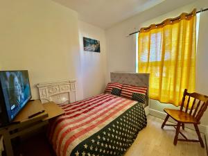 a bedroom with a bed and a desk and a television at 1 Bed & Breakfast West Brom in West Bromwich +3 photos