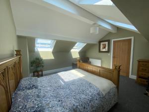 a bedroom with a bed and skylights at The Dales in Marshside