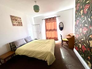 a bedroom with a bed and a desk and a window at 1 Bed & Breakfast West Brom in West Bromwich