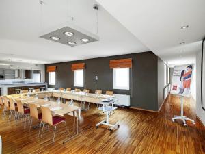 a large room with a long table and chairs at Ibis Praha Old Town in Prague
