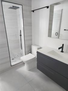 a bathroom with a toilet and a sink and a shower at JBMANORS in Fort Lauderdale