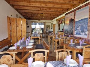 a dining room with wooden tables and chairs at Konoba Taline Sokolac in Rešetnica
