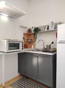 a kitchen with a sink and a microwave at Apartment Cimbora, Salara farmhouse in Koper +28 photos