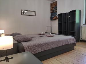 a bedroom with a bed and a table with a lamp at Apartment Cimbora, Salara farmhouse in Koper