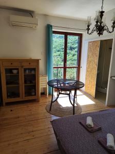 a living room with a table in front of a window at Apartment Cimbora, Salara farmhouse in Koper