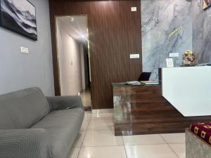 a living room with a couch and a table at Aditya Residency, Bhagalpur in Barāri +1 photo