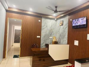 a lobby with a stone wall with a tv on it at Aditya Residency, Bhagalpur in Barāri