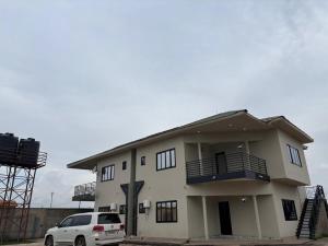 a white car parked in front of a house at KATEL Green appartements in Kolwezi