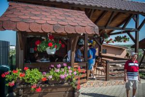 a woman standing in front of a flower shop at Casa Albă in Sănduleşti