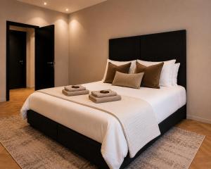 a large bed with two towels on top of it at Breda Apartment w Kitchen & Private Bathroom 2p in Breda