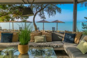 a living room with a couch and a table at Kalafatis beach home in Itea