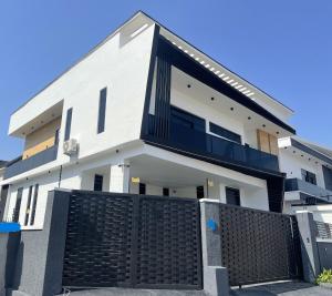 a white house with a black fence in front of it at Luxury 5 BR Villa with Pool,Cinema Lekki in Lekki