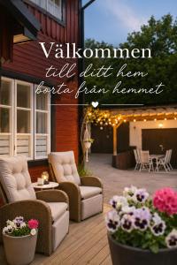 a patio with couches and flowers on a house at Central City Apartment A in Nyköping