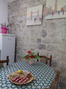 a table with a plate of food on top of it at Agica apartment in Škaljari