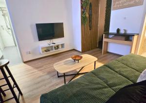 a living room with a couch and a table at L'Evasion Zen au cœur de l'Alsace in Sélestat
