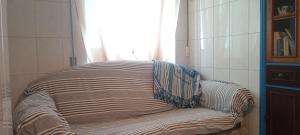 a bench in a room with a window at Casa Fuseta-38 in Fuzeta