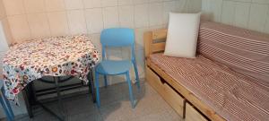 a room with two chairs and a table and a bed at Casa Fuseta-38 in Fuzeta