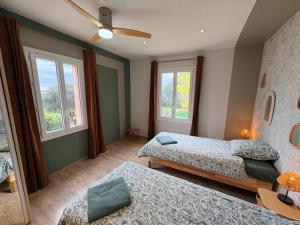 a bedroom with two beds and two windows at Batisse de vacance cadre exceptionnel in Fréjus +90 photos