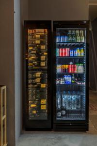 a refrigerator filled with lots of drinks and soda at Kalafatis beach home in Itea +46 photos