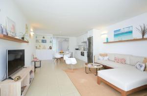 a living room with a couch and a tv at Beautiful Flat in Mont Choisy in Mont Choisy