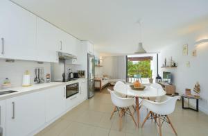 a kitchen and living room with a table and chairs at Beautiful Flat in Mont Choisy in Mont Choisy