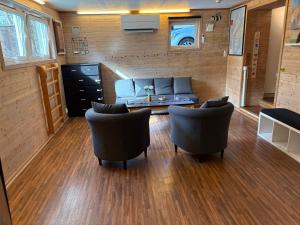 a living room with two chairs and a couch at Child friendly basement apartment in Stavanger