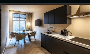 a kitchen with a table and a dining room at Breda Apartment w Kitchen & Private Bathroom 2p in Breda