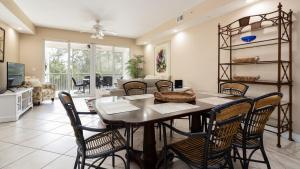 a dining room with a table and chairs at 611 Mariners Club in Key Largo
