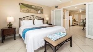 a bedroom with a large bed and a living room at 611 Mariners Club in Key Largo +45 photos