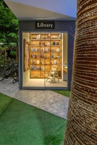 a library window with a table in it at Kalafatis beach home in Itea