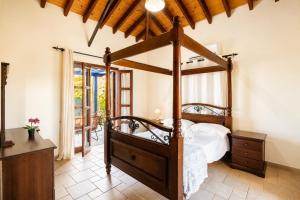 a bedroom with a four poster bed in a room at Villa River View in Peristerona +35 photos