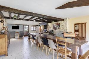 a kitchen with a large wooden table and chairs at La Ferme Des Bigornes in Châtillon-sur-Indre