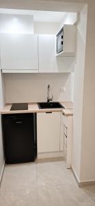 a small kitchen with a sink and a microwave at Xsoma Flats "Studio" in Thessaloniki +9 photos