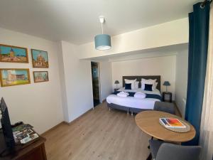 a bedroom with a bed and a table in it at Les Terres Noires in Serville