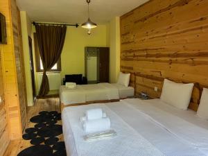 a bedroom with two beds with towels on them at Lapera Otel in Borçka