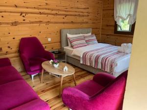 a bedroom with a bed and two chairs and a table at Lapera Otel in Borçka