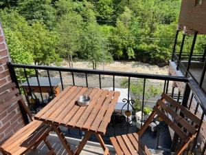 a wooden table and two chairs on a balcony at Lapera Otel in Borçka