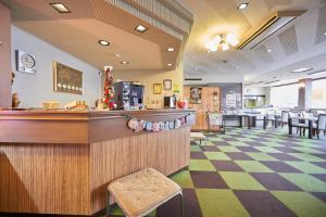 a bar in a restaurant with a checkered floor at Select Inn Yonezawa in Yonezawa