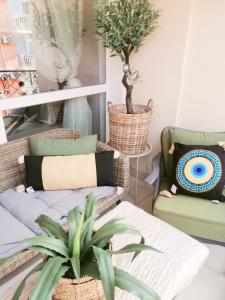 a living room with two chairs and a plant at Luxury Studio with Balcony in Sunny Beach