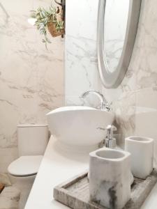 a white bathroom with a toilet and a sink at Luxury Studio with Balcony in Sunny Beach