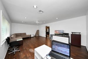 a living room with a laptop computer on a desk at Lofty Grace Home 2 in Richmond +25 photos
