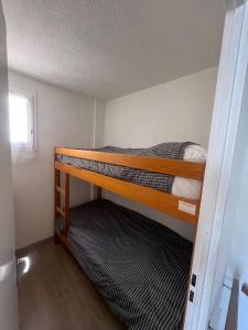 a small room with two bunk beds in it at Maisonnette les Marines d'Helios T2 cabine in Marseillan +22 photos