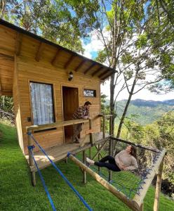 two people on the porch of a tiny house at Villa Colombia in Vianí