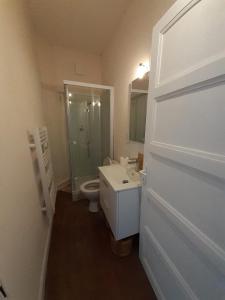 a bathroom with a toilet and a sink and a shower at Les Tournesols in Égletons