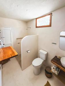 a bathroom with a toilet and a sink at Casa Martine in El Cuyo +34 photos