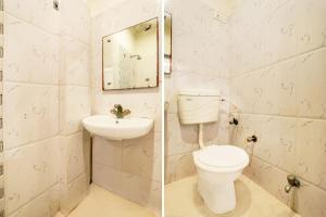 a bathroom with a toilet and a sink at Hotel O Taj Nagri Near Taj Mahal East Gate Formerly Riviera in Agra