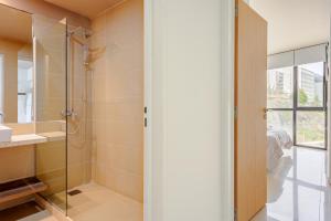 a bathroom with a shower and a glass door at Kóor Stays - Australis in Ushuaia +73 photos